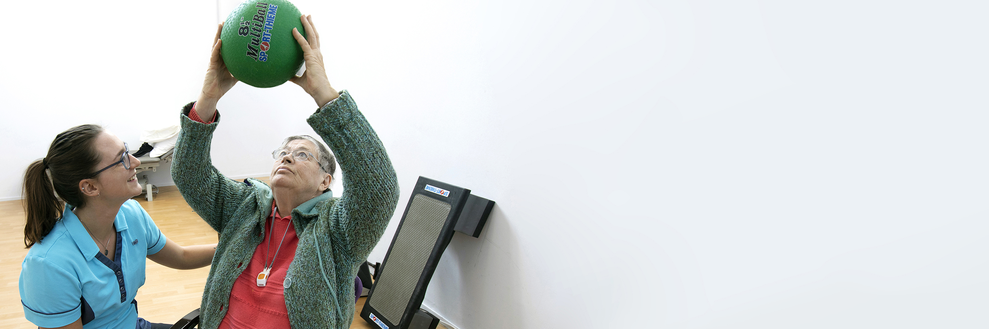 Fysiotherapeut en man doen oefening met bal